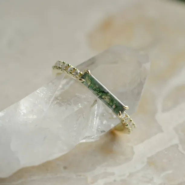 Close-up of the baguette moss agate and diamonds on the MILA engagement ring