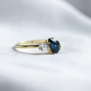 Close-up of the COUPLE Toi et Moi engagement ring with blue pear sapphire and diamond
