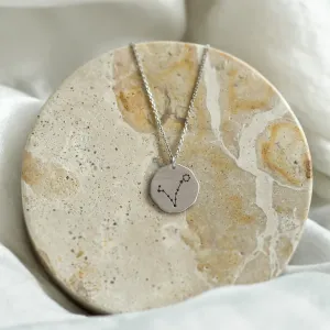 Gold STELLARIS necklace shown in a full view with engraved zodiac constellation
