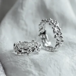 Angled view of NALANI wedding rings with organic elements