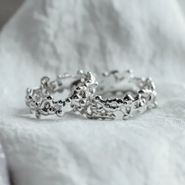 Close-up of NALANI avant-garde wedding rings with organic elements