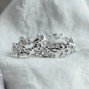 Close-up of NALANI avant-garde wedding rings with organic elements