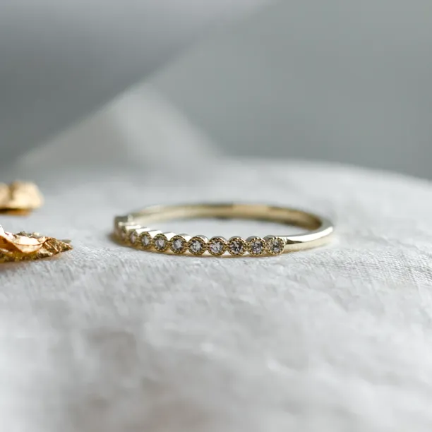 Close-up of the diamond-set band on the CHRISTINE gold ring