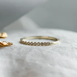 Close-up of the diamond-set band on the CHRISTINE gold ring