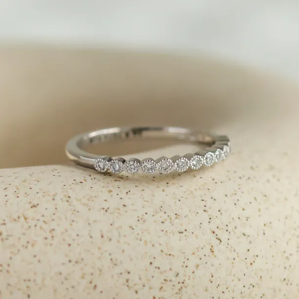 Angled view of the CHRISTINE gold ring with diamonds in half eternity design