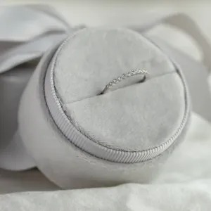 Close-up of the CHRISTINE gold ring with diamonds on a jewelry cushion