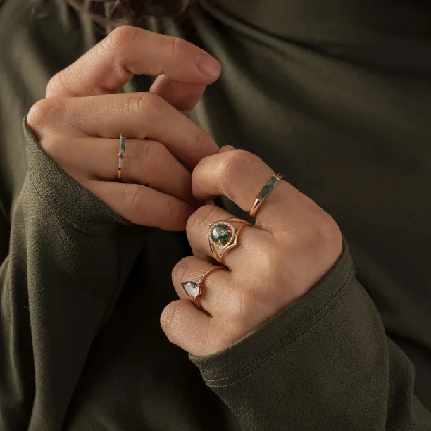 PINIA gold ring with moss agate and diamonds shown on a hand