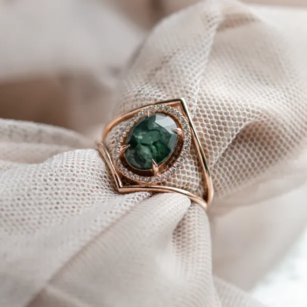 Close-up detail of the PINIA ring with moss agate and diamonds