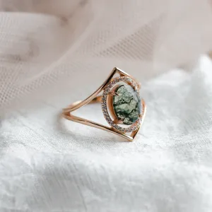 Angled view of the gold PINIA ring with moss agate and diamond surround