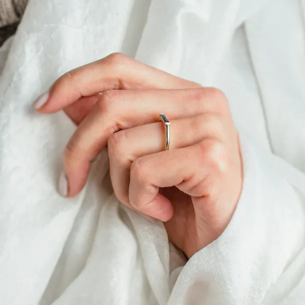 Gold CYNTHIA ring with laboratory sapphire worn on the finger