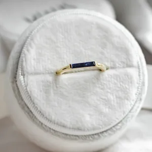 Close-up of the gold CYNTHIA ring with its blue baguette sapphire