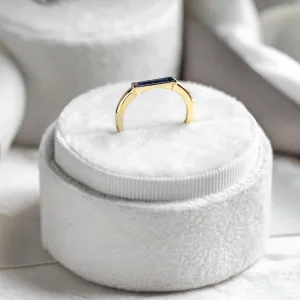 Angled detail of the gold CYNTHIA ring and baguette laboratory sapphire