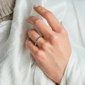Gold CYNTHIA ring with laboratory sapphire worn on the hand, angled view
