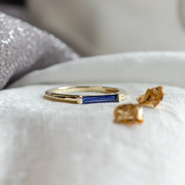 Angled view of the CYNTHIA gold ring with a blue laboratory sapphire
