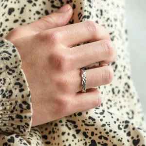 ANJA textured wedding ring worn on a hand