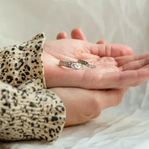 ANJA wedding rings resting in an open hand