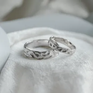 Angled view of ANJA wedding rings with textured surfaces