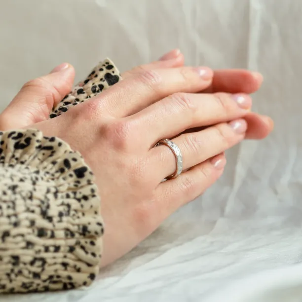 ANJA textured wedding ring worn on the finger