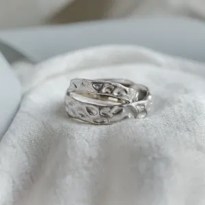 Close-up of overlapping ANJA wedding rings and their textured surfaces