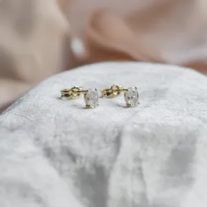 Angled view of CAROLYNE gold earrings with oval moissanites and backs