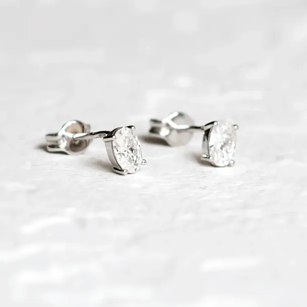 CAROLYNE gold minimalist earrings with oval moissanites, angled close-up