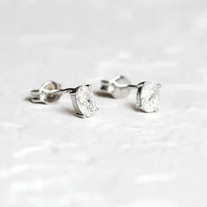 CAROLYNE gold minimalist earrings with oval moissanites, angled close-up