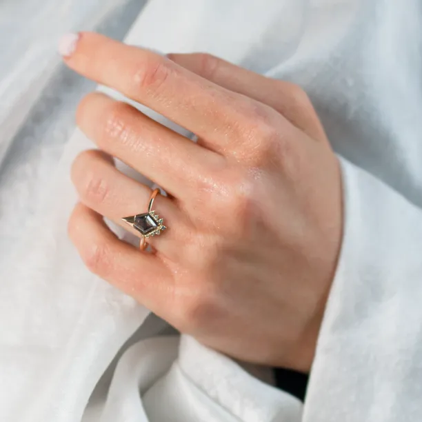 ADIRA engagement ring with salt and pepper diamond worn on a hand