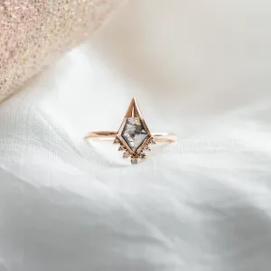 Close-up of ADIRA engagement ring with salt and pepper diamond and surrounding side diamonds