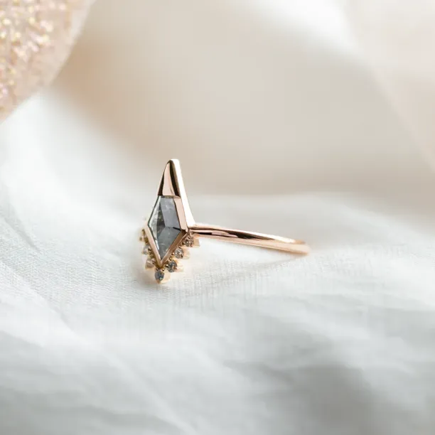 Side view of ADIRA engagement ring showing its salt and pepper diamond and side diamonds