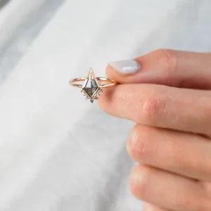 ADIRA engagement ring with salt and pepper diamond held between fingers