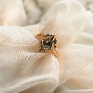 Angled close-up of ADIRA engagement ring with central salt and pepper diamond and side diamonds
