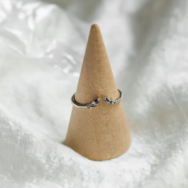 Gold open ring with salt and pepper diamonds on a ring holder