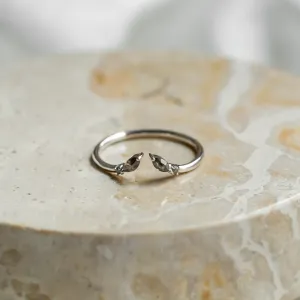 Gold open ring with salt and pepper diamonds, shown from an angle