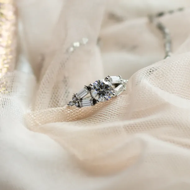 Close-up of the GINNY ring with round and baguette-shaped moissanites