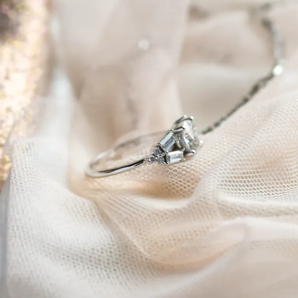 Angled close-up of the GINNY atypical ring with moissanites