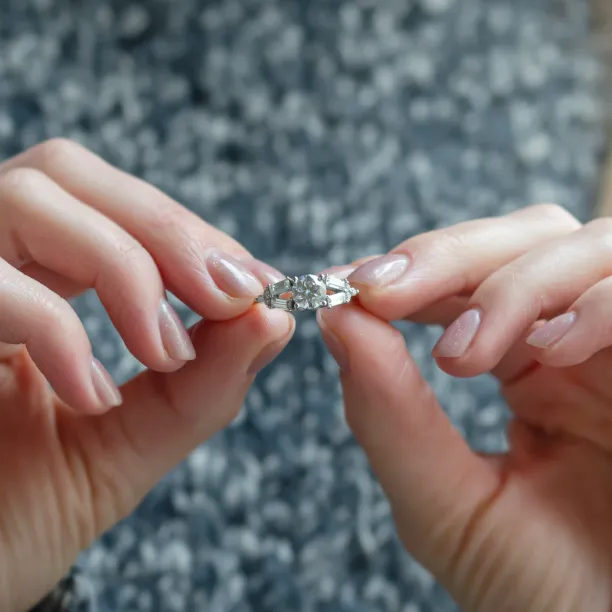 GINNY atypical ring with moissanites held between fingers