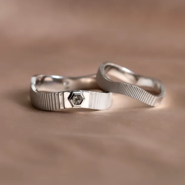 JACKLYN wedding rings in an angled view, highlighting the salt and pepper diamond