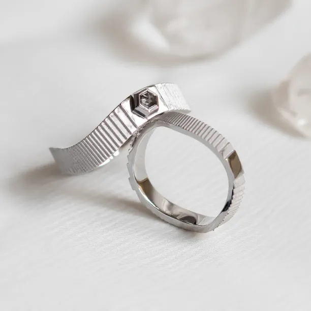 Close-up of JACKLYN wedding rings showing the diamond detail and textured bands