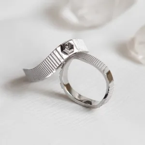 Close-up of JACKLYN wedding rings showing the diamond detail and textured bands