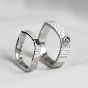JACKLYN wedding rings displayed upright, with textured bands and salt and pepper diamond