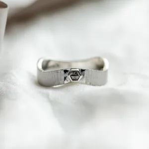 Close-up of a JACKLYN wedding ring with salt and pepper diamond and textured band