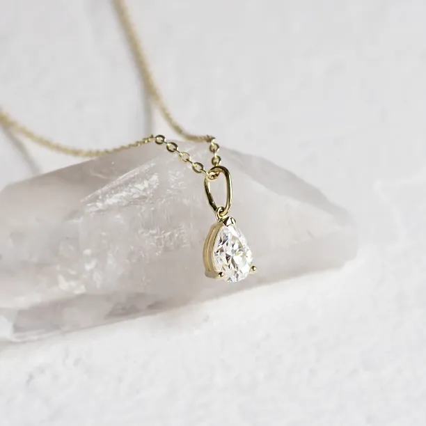 NAOMI necklace with pear moissanite in yellow gold, angled pendant detail