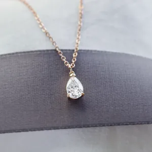 Close-up of the pear moissanite pendant on the NAOMI gold necklace