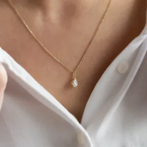 Gold necklace with pear moissanite NAOMI worn on the neck, close-up