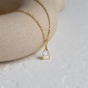 Angled close-up of the pear moissanite pendant on the NAOMI gold necklace