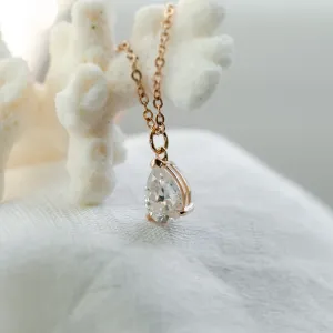 Close-up of the gold NAOMI necklace with pear moissanite pendant