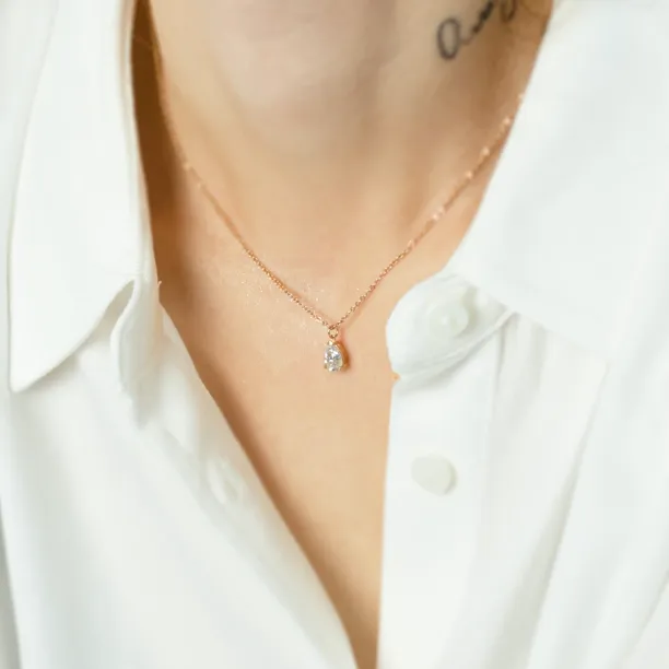 Gold NAOMI necklace with pear moissanite worn on the neck