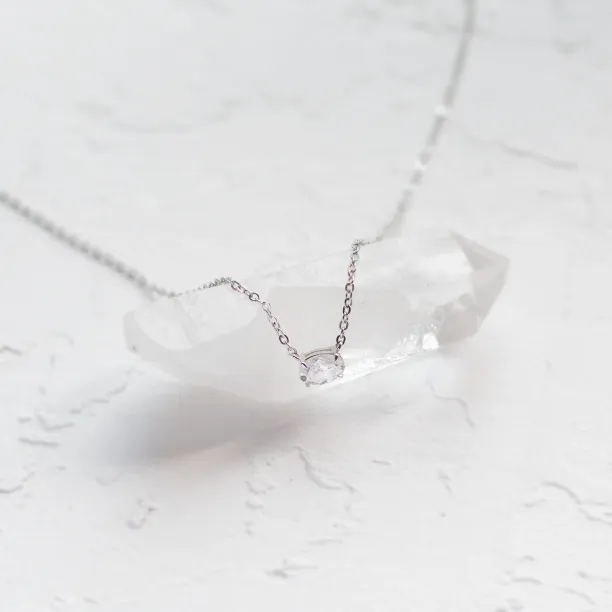 Angled view of the ARIA gold necklace with oval moissanite