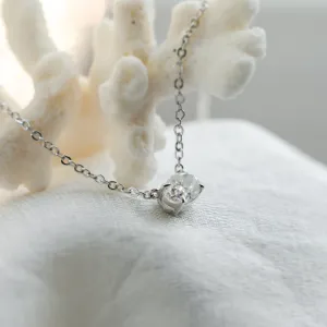 Angled close-up of the oval moissanite pendant on the ARIA gold necklace