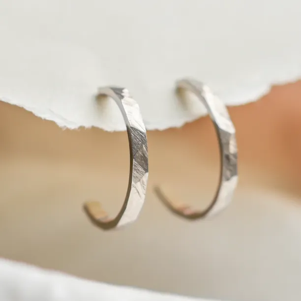 Gold circle earrings ABBY with a shiny hammered surface, close-up of the pair